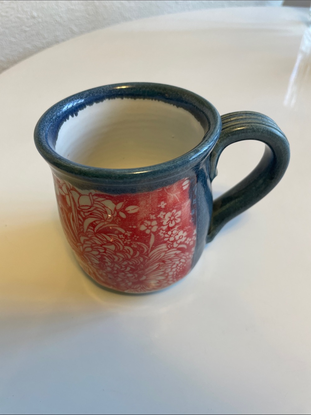 Handcrafted Red Floral Ceramic Mug with Blue Rim